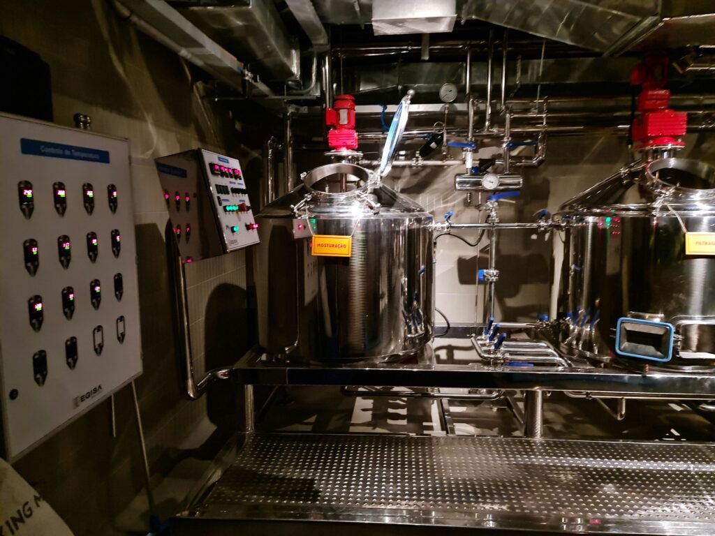Industrial processing tanks and control panel in manufacturing facility