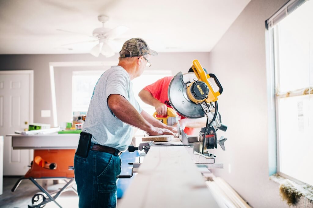 Professional carpenter repairing damaged wooden trim and structural woodwork inside a residential property to improve safety and long-term durability.