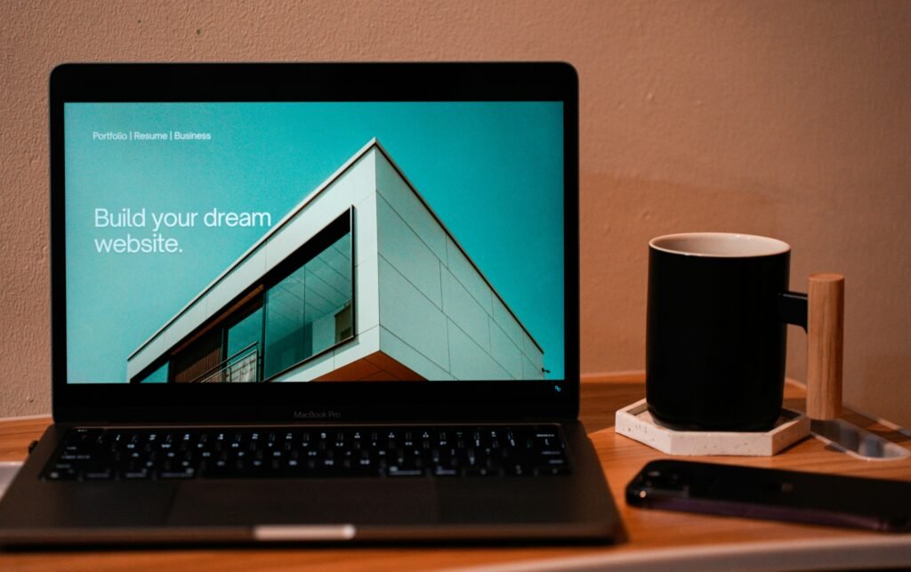 Small business owner comparing Weebly's plans on a laptop with website builder tools, branding elements, and e-commerce features.