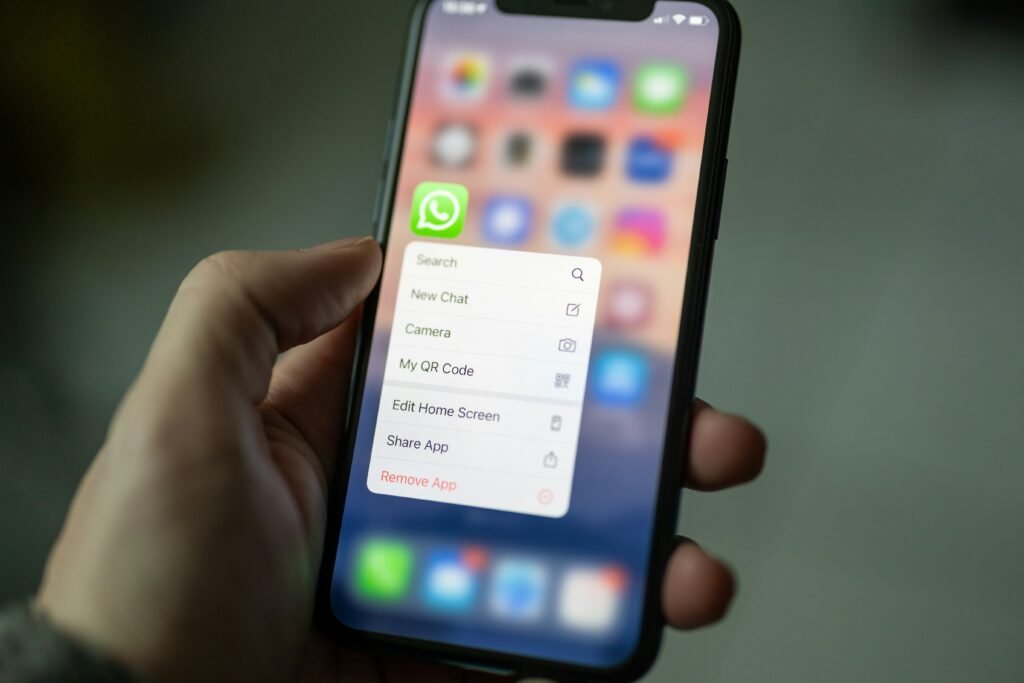 Smartphone displaying WhatsApp chat screen with privacy and screenshot notification concept for secure messaging awareness.