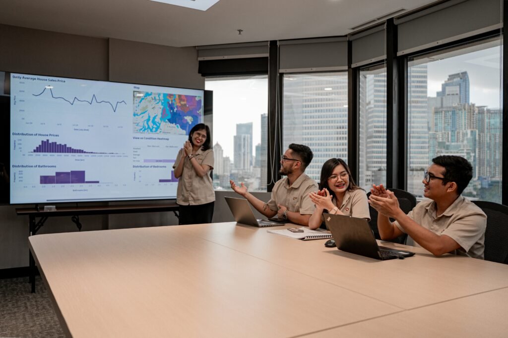 Professionals analyzing business data and dashboards in an online MSBA program environment focused on leadership and analytics.
