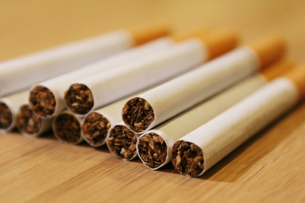 Close-up of an opened cigarette pack with dry tobacco and aging cigarettes, illustrating cigarette expiration, stale tobacco, and storage-related freshness loss.