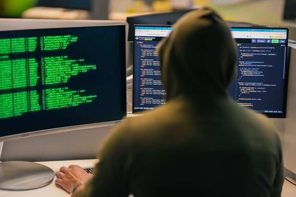 IT administrator monitoring autonomous endpoint management software dashboard with remote devices, cybersecurity alerts, and automation analytics.