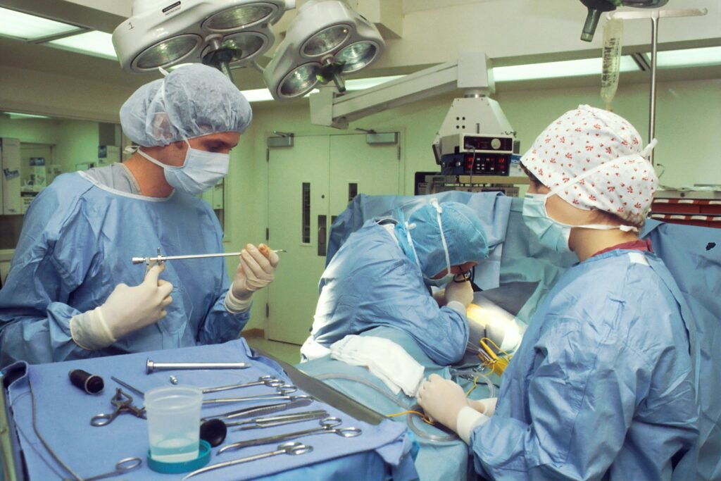 Anesthesia technician preparing anesthesia equipment in a modern hospital operating room before surgery.