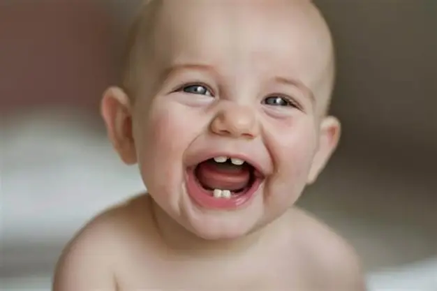 Child smiling with a missing front baby tooth while holding a loose tooth, illustrating when kids start losing teeth and normal dental development.