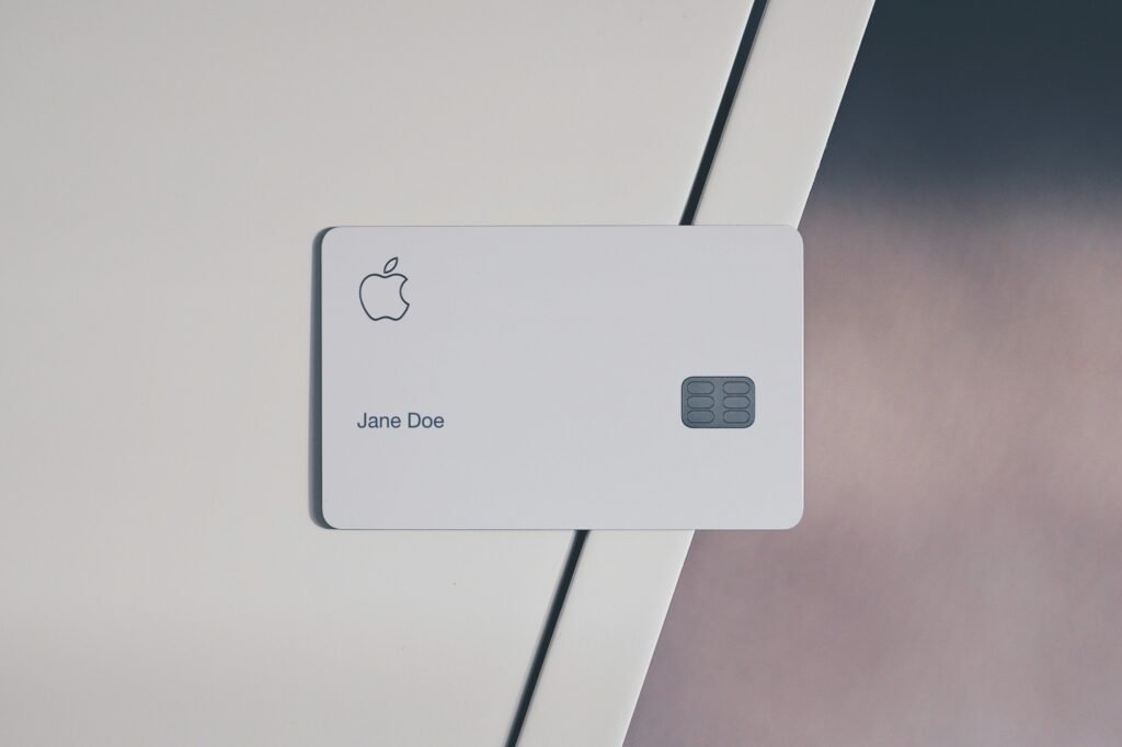 Apple Card with iPhone Wallet app showing cash back rewards and Apple Pay spending.