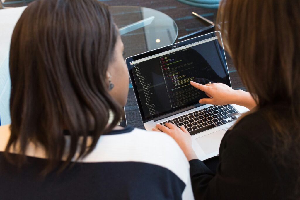 Modern business professionals analyzing digital dashboards and cloud technology infrastructure in a corporate office, representing IT solutions, cybersecurity, and business growth.