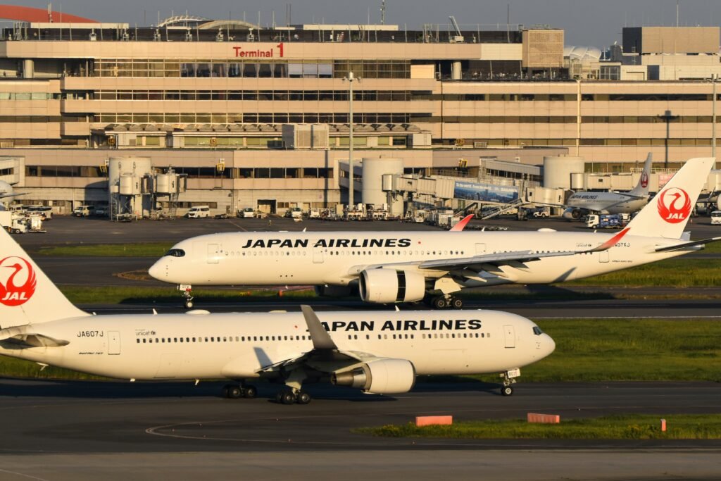 Luxury Japan Airlines Business Class cabin featuring lie-flat seats, elegant lighting, premium dining service, and a modern long-haul travel experience.