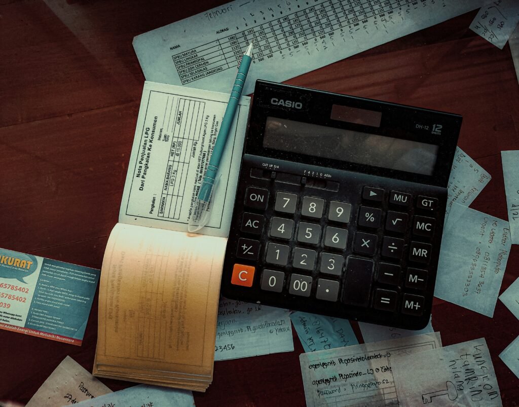 Professional accountant reviewing financial reports and business performance dashboards for a growing small business in a modern office environment.