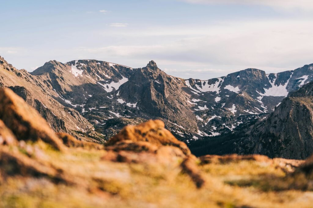 Scenic Colorado landscape featuring Rocky Mountains, alpine lakes, red rock formations, and charming mountain towns