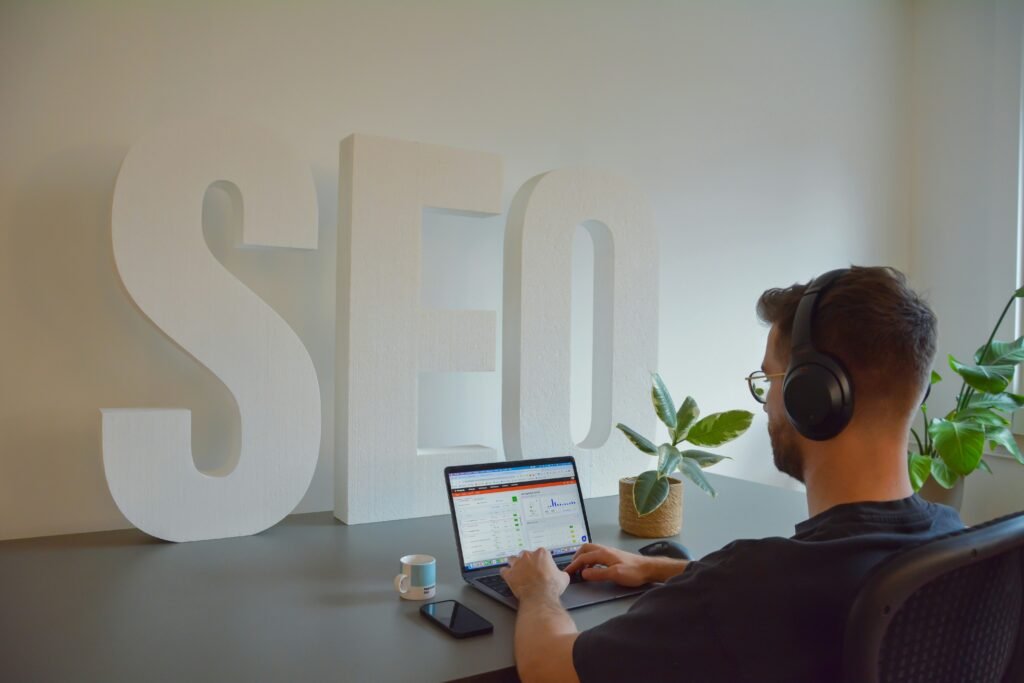 Digital marketing professional analyzing SEO performance metrics and search rankings for small business growth on a modern dashboard.