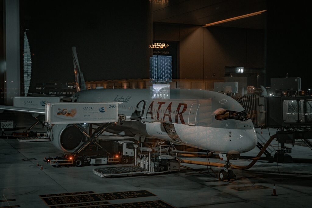 Qatar Airways Business Class Qsuite cabin featuring lie-flat seats, private suites, premium dining, and luxury air travel experience
