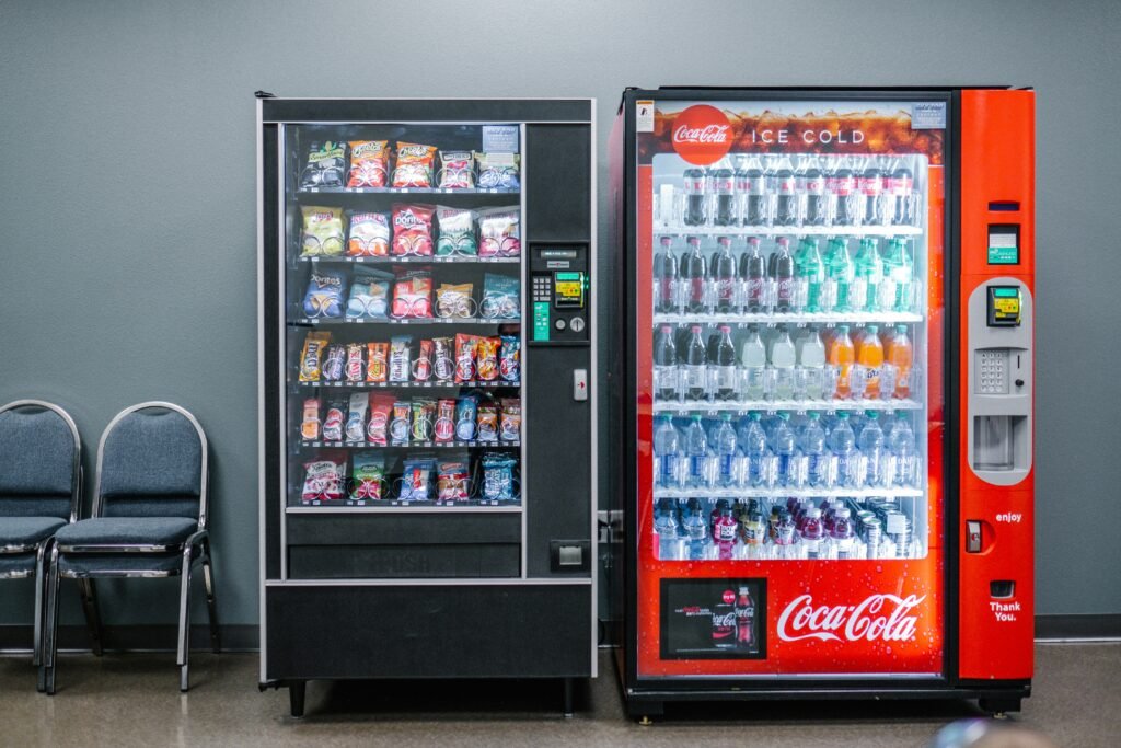 New vending machine displaying snacks and beverages with pricing, illustrating the cost of buying a vending machine in 2026.