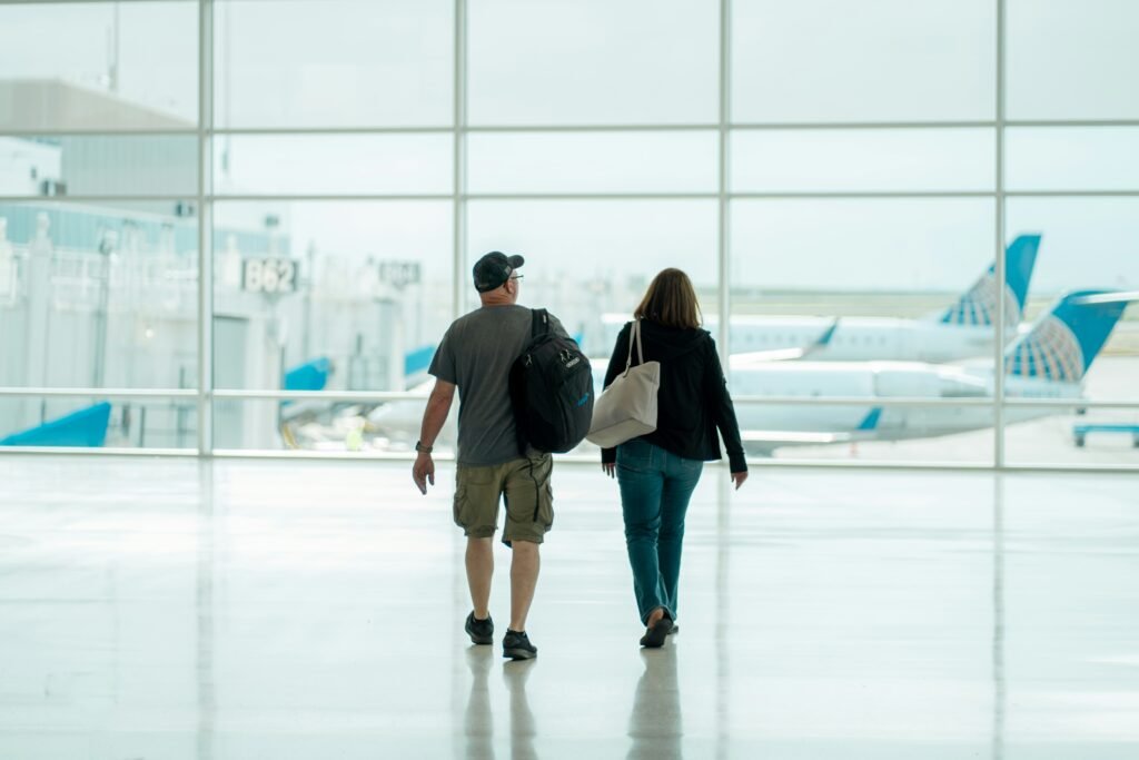 Traveler comparing flight discounts on a laptop while reviewing travel deals and promotional booking offers.