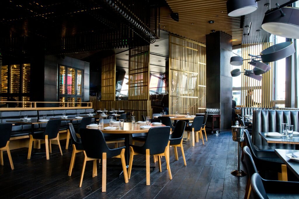 Exterior of an 801 Chophouse restaurant with diners entering while the parent company undergoes Chapter 11 business restructuring.