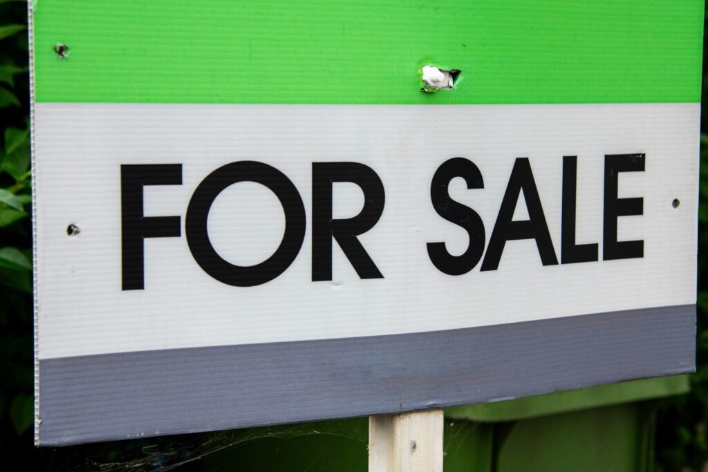 Entrepreneur reviewing documents and shaking hands after purchasing a business in a modern office setting.